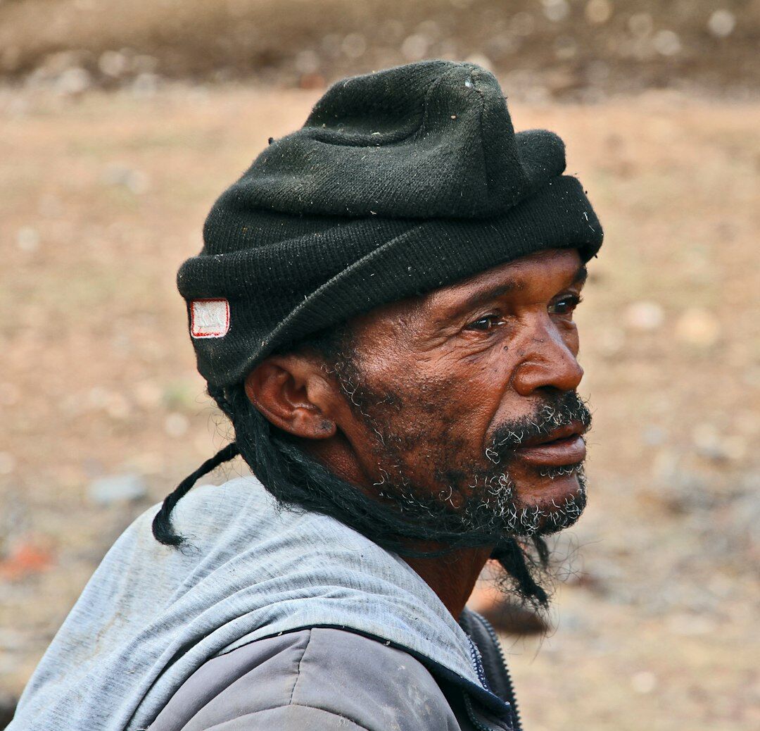Weathered Chilean fisherman standing by fishing boats in Valparaiso